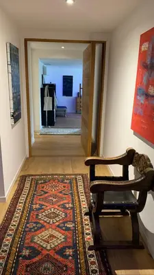 a hallway with a rug and a chair in a room at Villa Leccia di Lorello in Grosseto-Prugna