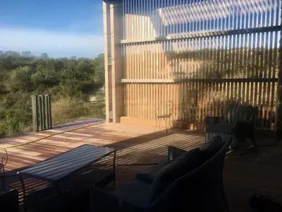 a wooden deck with a bench and a fence at Villa Leccia di Lorello in Grosseto-Prugna