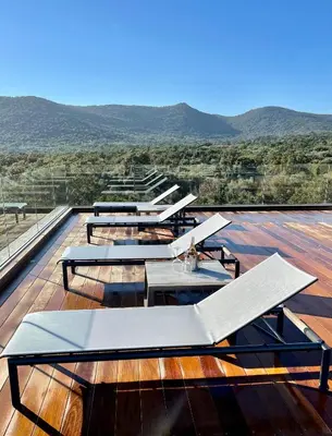 a group of tables on the roof of a building at Villa EVA, vue mer et montagne, plage à pieds in Sainte-Lucie de Porto-Vecchio