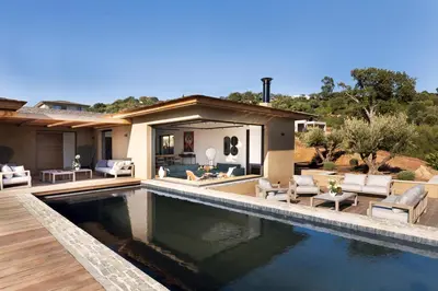 a home with a swimming pool and a house at Villa EVA, vue mer et montagne, plage à pieds in Sainte-Lucie de Porto-Vecchio