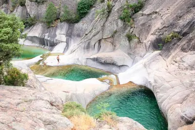 a person standing in a pool of water in a canyon at Campo Vecchio Mare et Piscine in Ghisonaccia