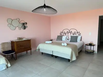 a bedroom with a bed and a dresser and a bed sidx sidx sidx sidx at Villa Mare d'argentu La solenzara in Sari Solenzara