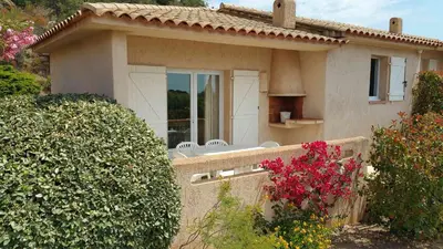 a small house with a fence in front of it at Résidence Liccia di Furu in Porto-Vecchio