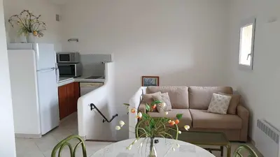 a living room with a couch and a table at Résidence Liccia di Furu in Porto-Vecchio