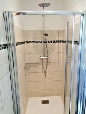 a shower with a glass door in a bathroom at U mè sognu in Arbellara