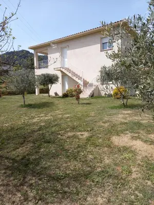 a house with a large yard in front of it at U SOLE in Ajaccio