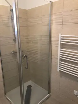 a shower with a glass door in a bathroom at U SOLE in Ajaccio