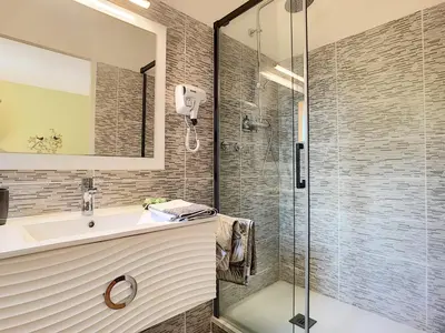 a bathroom with a sink and a glass shower at Alegria in Arbellara