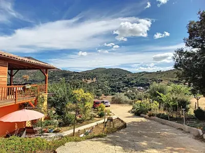 a house with a balcony with a view of the mountains at Alegria in Arbellara