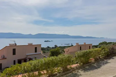 a view of the ocean from a house at La Punta Geronimi in Porto Pollo