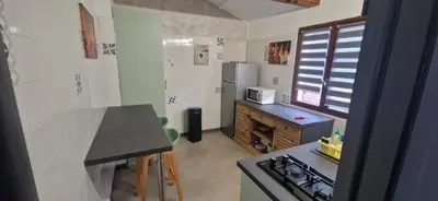 a small kitchen with a counter and a refrigerator at Casa Del Torrente in Porto Ota