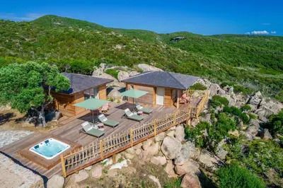 an aerial view of a house on a rocky hill at Domaine & Villas Version Maquis in Bonifacio