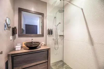 a bathroom with a sink and a shower at Domaine & Villas Version Maquis in Bonifacio