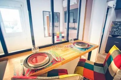a table with a plate of watermelon on it at Studio cosy les pieds dans l'eau, climatisé, Parking privé, Vue montagne in San-Nicolao