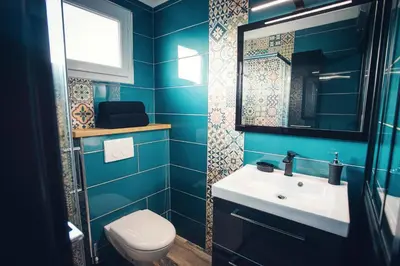a blue bathroom with a sink and a toilet at Studio cosy les pieds dans l'eau, climatisé, Parking privé, Vue montagne in San-Nicolao