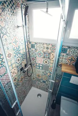 a bathroom with a shower with mosaic tiles on the wall at Studio cosy les pieds dans l'eau, climatisé, Parking privé, Vue montagne in San-Nicolao