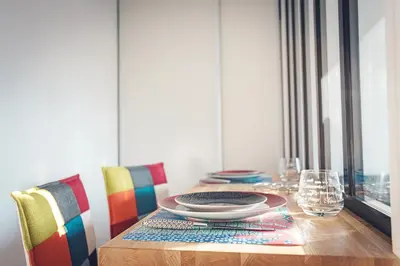 a dining room table with a plate on top of it at Studio cosy les pieds dans l'eau, climatisé, Parking privé, Vue montagne in San-Nicolao