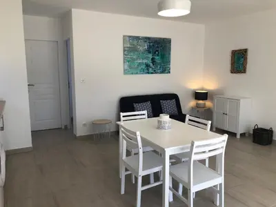a dining room with a white table and chairs at U MANDARINU in Ajaccio