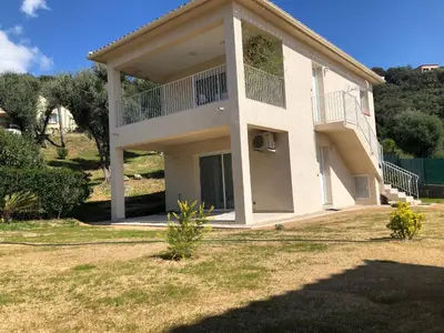 a house with a balcony on the side of it at U MANDARINU in Ajaccio