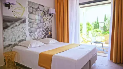 a bedroom with a bed and a large window at Casa Nova Maison d'hôtes in Sagone