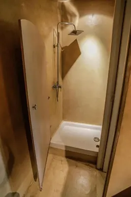 a bathroom with a shower and a tub at Chambre d'hôtes couvent d'Alando in Alando