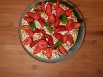 a cake with strawberries on top of it on a table at Chambre d'hôtes couvent d'Alando in Alando