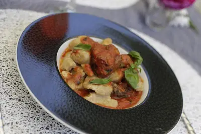 a bowl of food on a plate on a table at Chambre d'hôtes couvent d'Alando in Alando