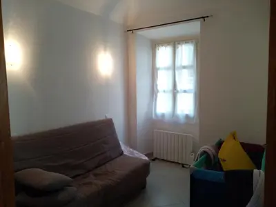 a living room with a couch and a window at Appartement cours Bonaparte in Sartène
