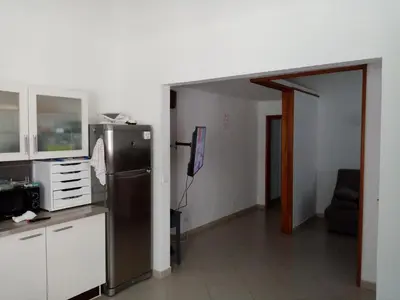 a kitchen with a refrigerator and a living room at Appartement cours Bonaparte in Sartène