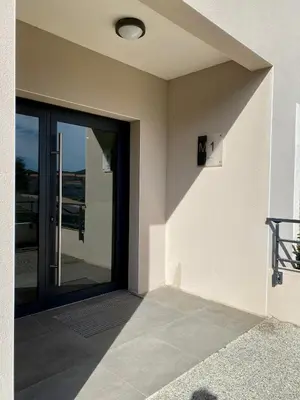 a door to a building with a glass door at Studio tout confort en centre ville in Propriano