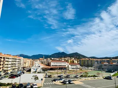 a city with cars parked in a parking lot at Studio tout confort en centre ville in Propriano
