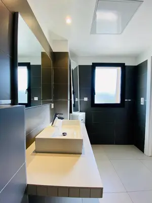 a bathroom with a sink and a mirror at Studio tout confort en centre ville in Propriano