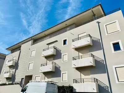 a white van parked in front of a building at Studio tout confort en centre ville in Propriano