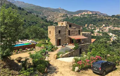 a car parked in front of a house on a mountain at Awesome Home In Ville-Di-Paraso in Ville-di-Paraso