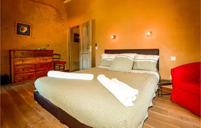 a bedroom with a large bed with white pillows at Awesome Home In Ville-Di-Paraso in Ville-di-Paraso