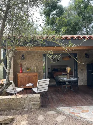 a swimming pool in a yard with flowers at A Vadina Suite et chambres de charme Porticcio in Porticcio