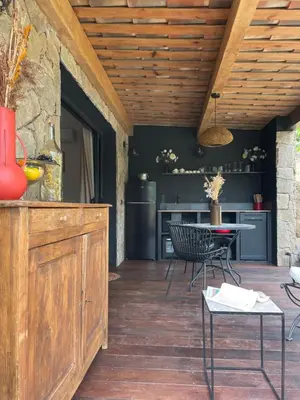 a kitchen with a refrigerator and a stove at A Vadina Suite et chambres de charme Porticcio in Porticcio