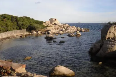 a large body of water with rocks in it at Casa Murtetu 3 étoiles in Porto-Vecchio