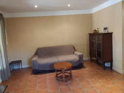 a small bedroom with a bed and a table at Casa Murtetu 3 étoiles in Porto-Vecchio