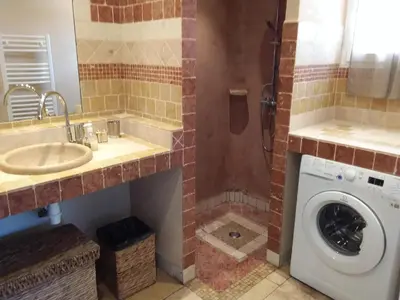 a bathroom with a sink and a washing machine at Casa Murtetu 3 étoiles in Porto-Vecchio