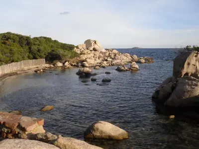 a large body of water with rocks in it at Casa Murtetu 3 étoiles in Porto-Vecchio