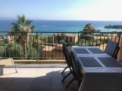 a table on a balcony with a view of the ocean at T2 route des sanguinaires vue mer panoramique in Ajaccio