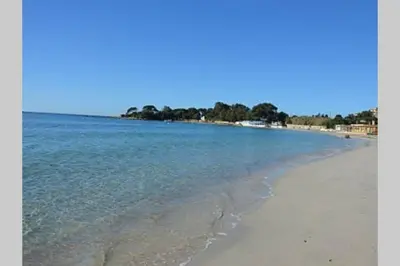 a view of a beach with the sand and water at T2 route des sanguinaires vue mer panoramique in Ajaccio