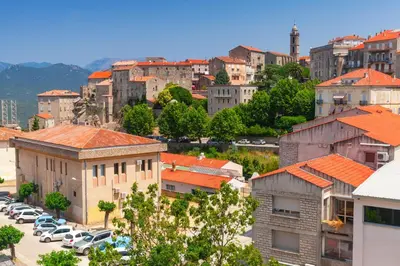 a city with cars parked in a parking lot at Camping Olva - Maeva in Sartène
