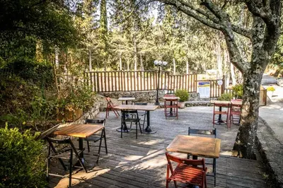 a group of tables and chairs on a wooden deck at Camping Olva - Maeva in Sartène