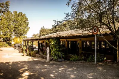 a building with a no parking sign in front of it at Camping Olva - Maeva in Sartène