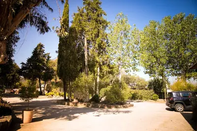 a car parked in a parking lot with trees at Camping Olva - Maeva in Sartène