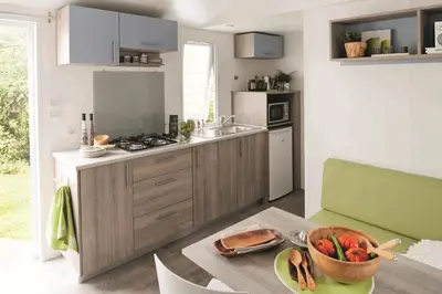 a kitchen with a bowl of fruit on a table at Camping Campo Di Liccia - Maeva in Bonifacio