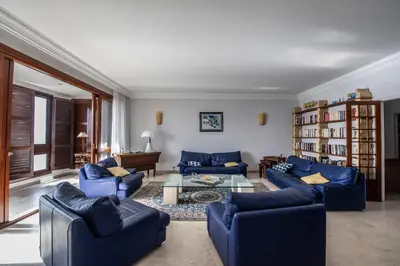 a living room with blue couches and a table at Appartement Front de Mer Hyper Centre in Ajaccio