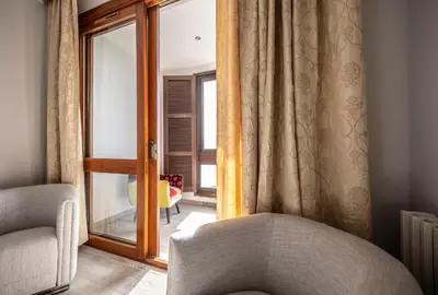 a living room with a chair and a window at Appartement Front de Mer Hyper Centre in Ajaccio